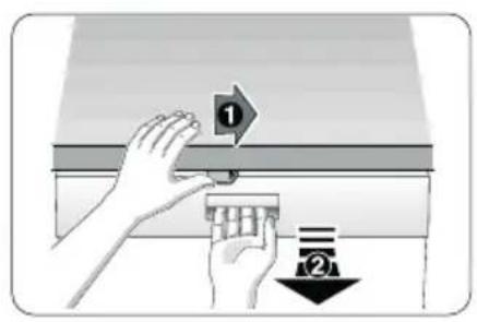 Diagram showing two hands holding a component with numbered labels, illustrating a process or procedure in a container.