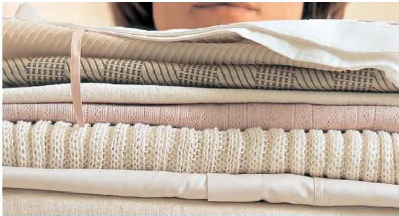Stacked fabric sheets with printed Chinese characters, likely textile or textile material
