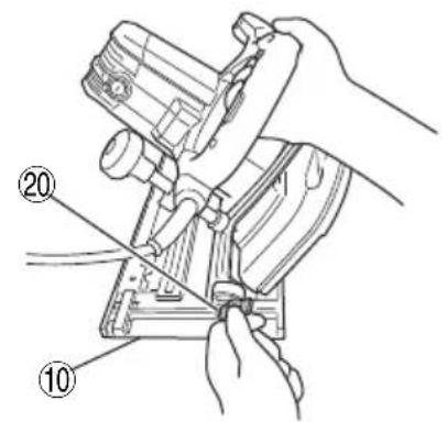 Technical diagram showing hands operating a mechanical device with numbered parts labeled 10 and 20