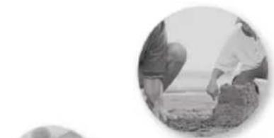 Black-and-white circular image showing two people working together, one crouching and the other kneeling (no visible text or symbols)
