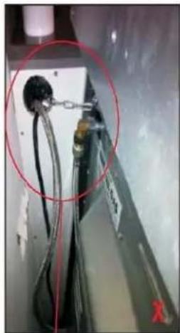 Close-up of a mechanical or electrical component with wires and connectors, circled in red (no visible text or symbols)