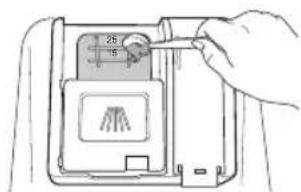 Diagram showing a hand inserting a device into a device with labeled dimensions and a small icon, likely illustrating a physical or engineering concept.