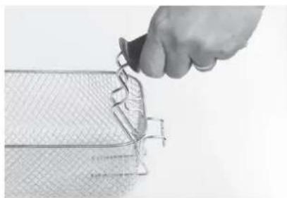 Hand holding a tool interacting with a meshed object, no visible text or symbols