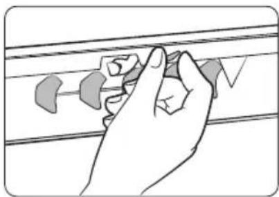 Hand holding a small object on a surface, no text or symbols visible