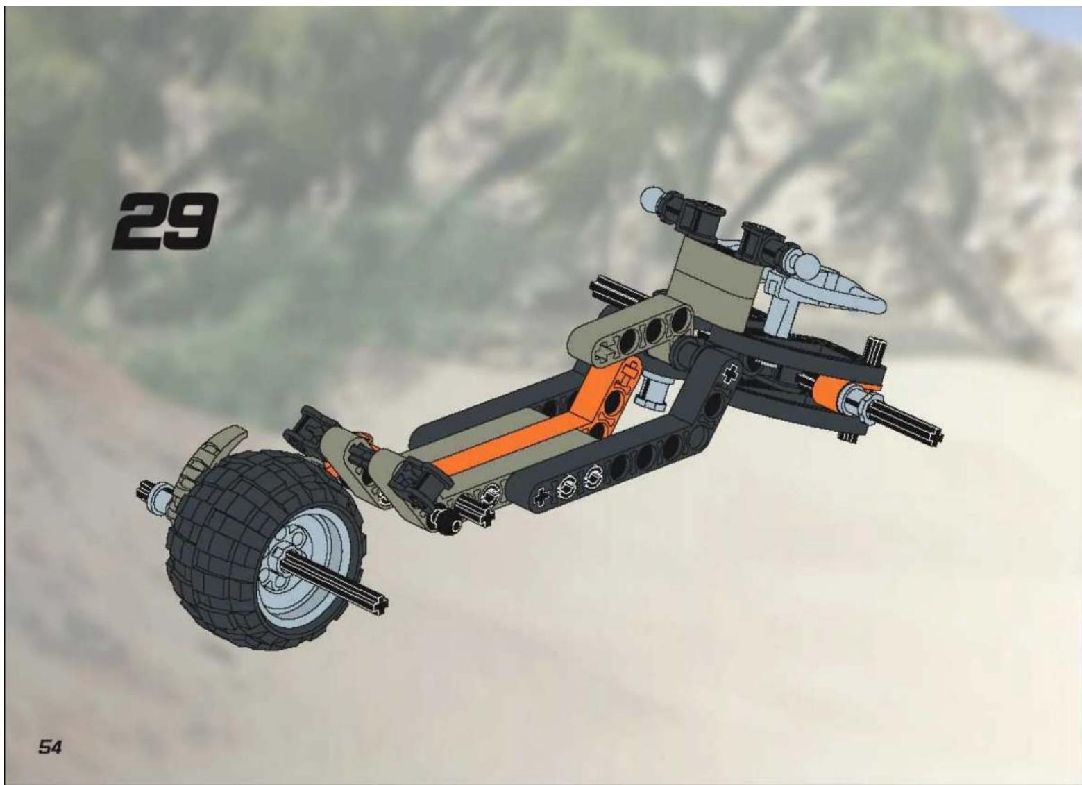 3D model of a tracked vehicle with visible engine components and wheels, set against a blurred mountainous background (no text or symbols)