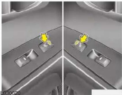 Close-up of a car interior showing two switches with yellow arrows pointing to them, no visible text or symbols