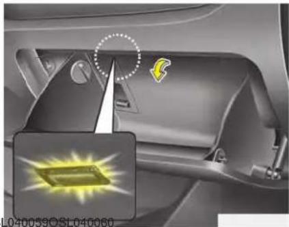 Interior view of a car showing a handle, intake manifold, and a highlighted component (no text or symbols visible)