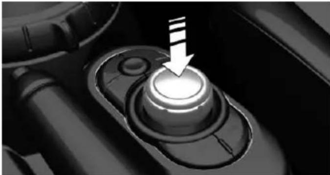Close-up of a mechanical component with a highlighted circular button and an arrow pointing to it (no text or symbols visible)