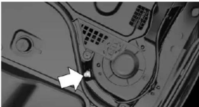 Close-up of a mechanical component with a white arrow pointing to a small feature (no visible text or symbols)