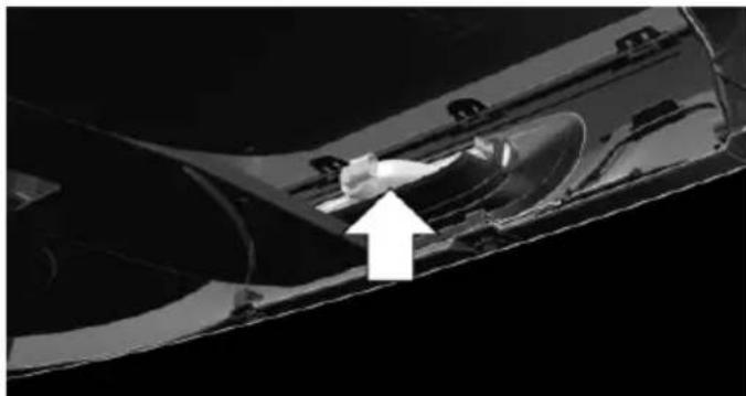 Close-up of a mechanical component with a white arrow pointing to a feature, no visible text or symbols