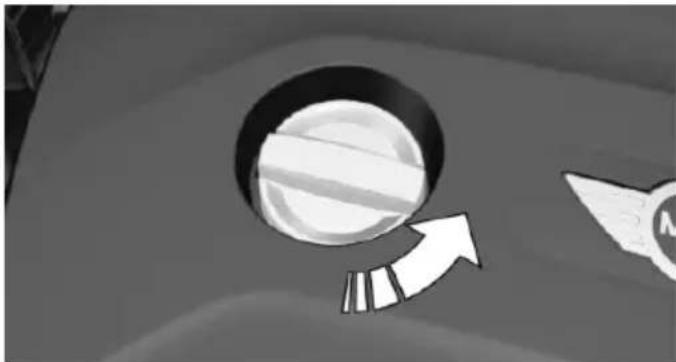 Close-up of a circular object with an arrow pointing upward, no visible text or symbols