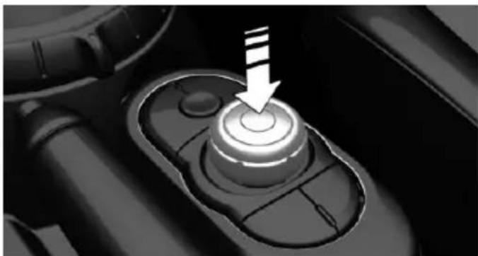Close-up of a mechanical gear shift lever with a white arrow pointing to the center (no text or symbols visible)