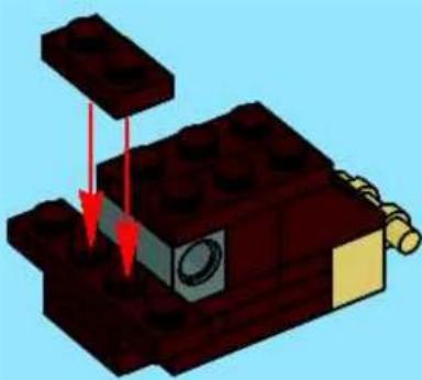 3D diagram of a mechanical assembly with red arrows indicating force or movement (no text or symbols)