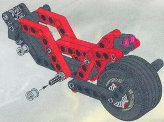3D illustration of a red and black mechanical vehicle chassis with visible springs and wheels (no text or symbols)