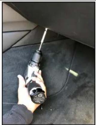 Close-up of hands using a power tool on a car tire (no visible text or symbols)