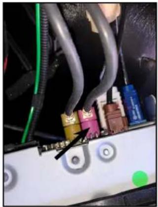 Close-up of a car's electrical panel with visible wiring and components (no readable text or symbols)
