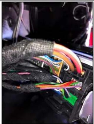 Close-up of a hand holding a car interior with colorful abstract objects (no visible text or symbols)