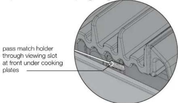 pass match holder through viewing slot at front under cooking plates