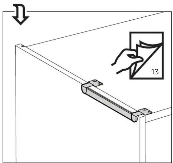 Diagram showing a hand holding a small object with number 13, alongside a mechanical bracket and directional arrow.
