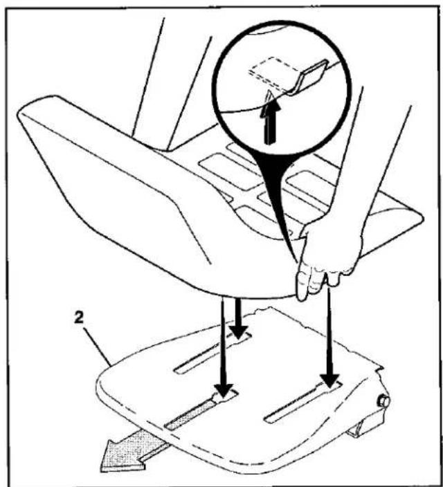 Diagram illustrating a hand operating a car seatbelt with labeled parts and a magnified inset showing the handle area.