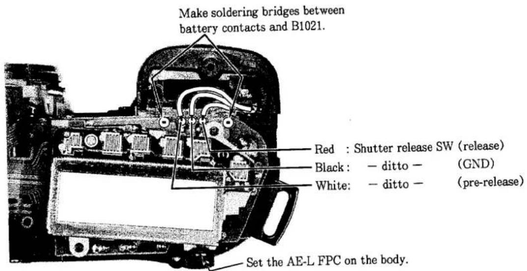 Make soldering bridges between battery contacts and B1021. Red : Shutter release SW (release) Black : - ditto - (GND) White: - ditto - (pre-release) Set the AE-L FPC on the body.