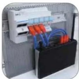 Electrical cabinet with blue cables and orange connectors mounted on a white rack (no visible text or symbols)