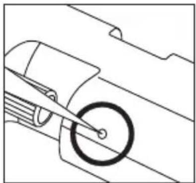 Technical line drawing of a mechanical component with a circular feature and tool (no text or symbols)