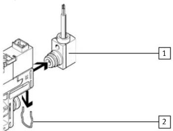 Diagram showing a mechanical component with labeled parts 1 and 2, and directional arrows indicating movement or force.