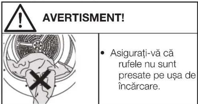 AVERTISMENT! Asigurați-vă că rufele nu sunt presate pe ușa de încărcare.