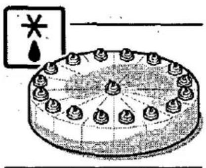 Diagram of a cake with decorative elements and a warning symbol, likely illustrating a safety or safety hazard.