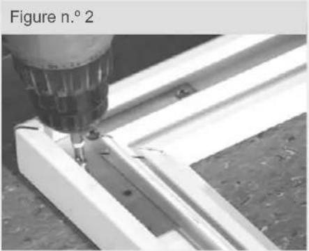 Close-up of a drill bit cutting through a metal frame (no text or symbols visible)