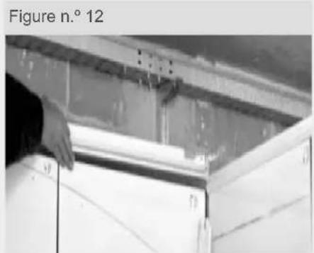 Person installing or adjusting a white cabinet or panel under a ceiling structure (no visible text or symbols)