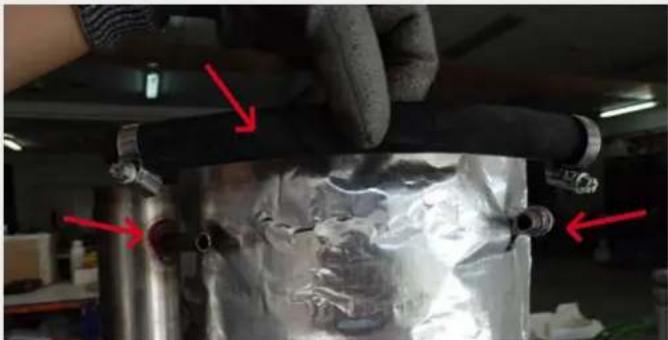 Close-up of a mechanical assembly with red arrows pointing to components, no visible text or symbols