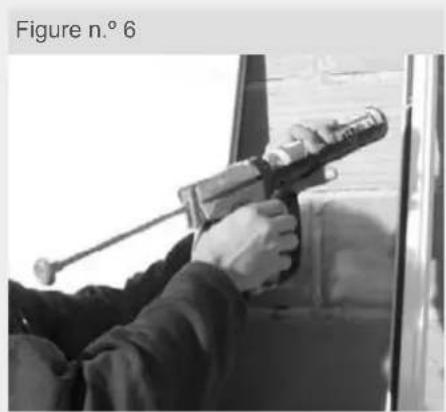 Person using a handheld tool on a vehicle door, no visible text or symbols
