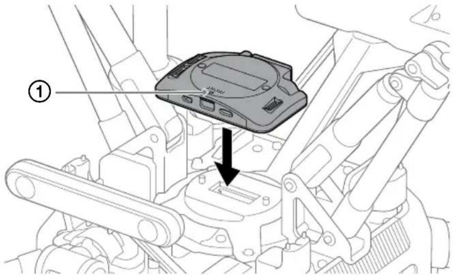 Technical diagram showing a device component with labeled parts and an arrow indicating assembly or inspection.