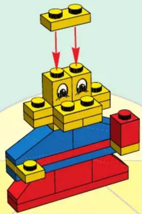 3D illustration of a LEGO structure with yellow and blue blocks and red base, featuring a face with eyes (no text or symbols)