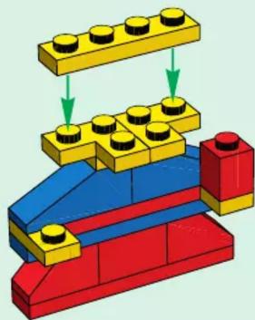 3D diagram of a LEGO structure with red, blue, and yellow blocks and green arrows indicating assembly or movement (no text or symbols)