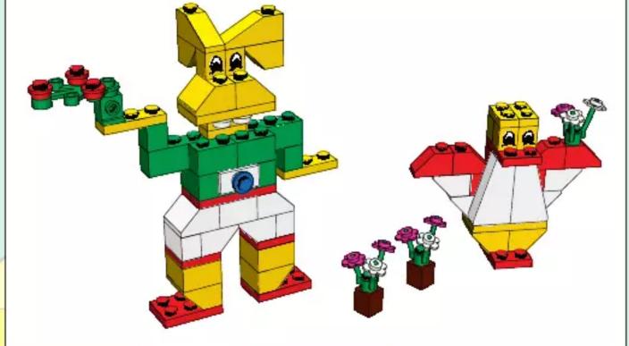 3D model of a colorful LEGO robot with green body, yellow face, and red accents, accompanied by two smaller flower-like structures (no text or symbols)