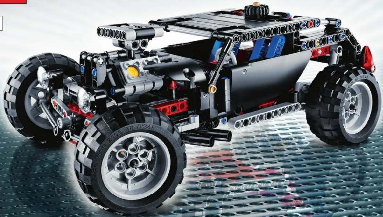 Close-up of a LEGO robotic car with exposed mechanical components and large tires, displayed on a perforated metal surface (no text or symbols visible)