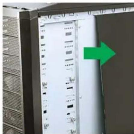 Close-up of a server rack with a green arrow pointing to a vertical panel, no visible text or symbols on the rack itself.