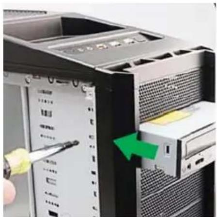 Close-up of a desktop computer tower with a green arrow indicating a cable being inserted (no text or symbols visible)