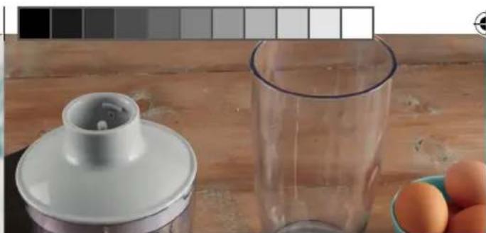 Close-up of a kitchen utensil and glass with eggs on a wooden surface (no text or symbols visible)
