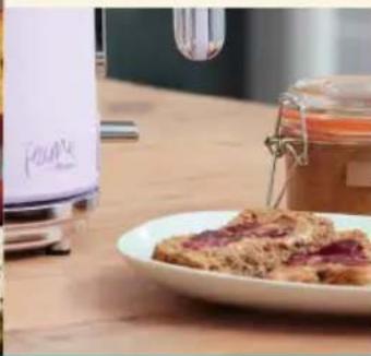 Close-up of a kitchen microwave with a glass jar and a plate of food, no visible text or symbols.