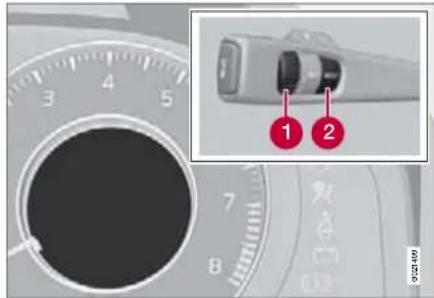 Diagram showing a car dashboard dial with labeled parts and an inset photo of a plug connector with two red annotations.