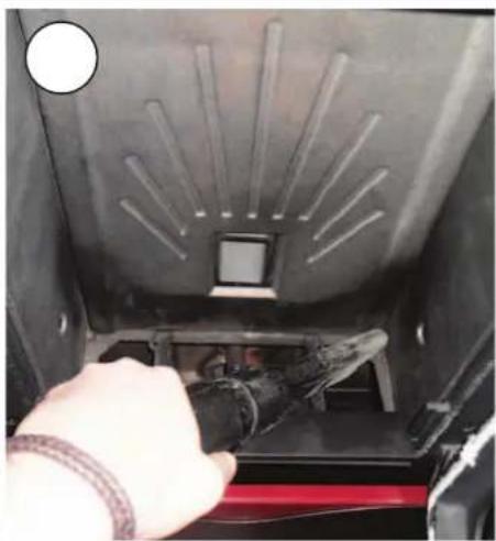 Close-up of a hand operating a mechanical device inside a vehicle (no visible text or symbols)