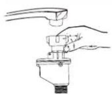 Line drawing of a hand holding a valve with a handle (no text or symbols).