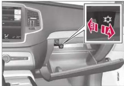 Car interior control panel with labeled directional indicators (BI, IA) and a warning symbol in the upper right corner.