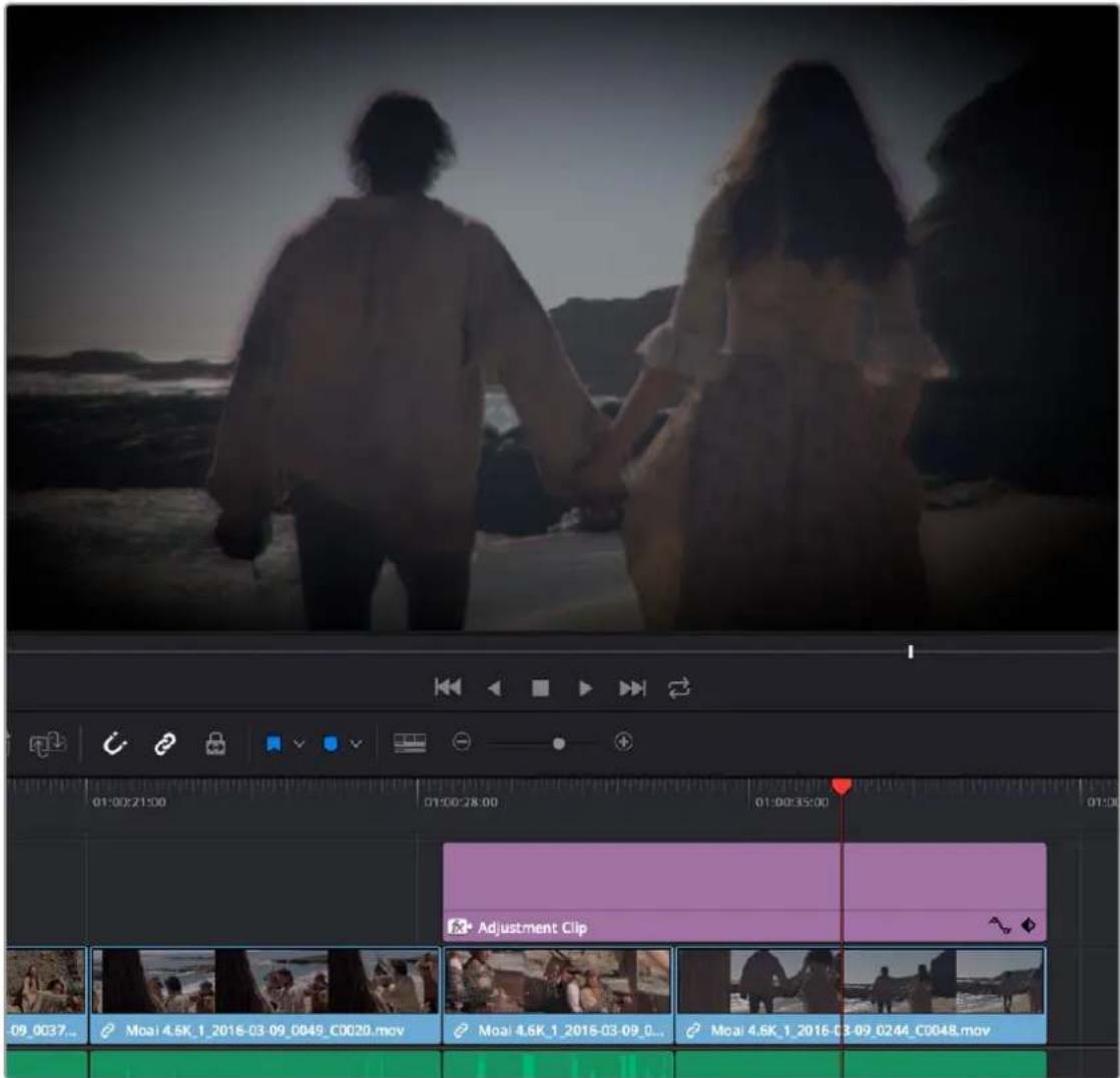 Video editing software interface showing a coastal scene with two silhouetted figures and timeline controls displaying clip names and timestamps.