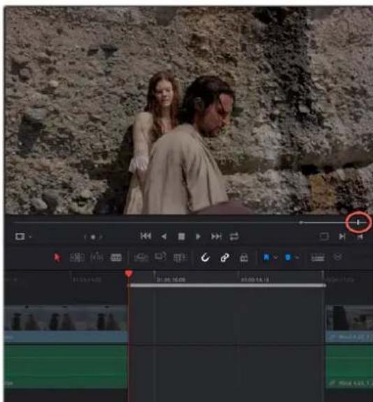 Video editing software interface showing timeline with two actors and a playhead, displayed on a rocky cliff background