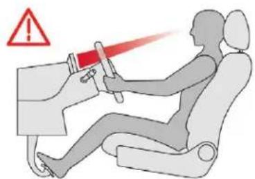 Safety warning illustration showing a person using a car simulator with red laser beam and warning symbol